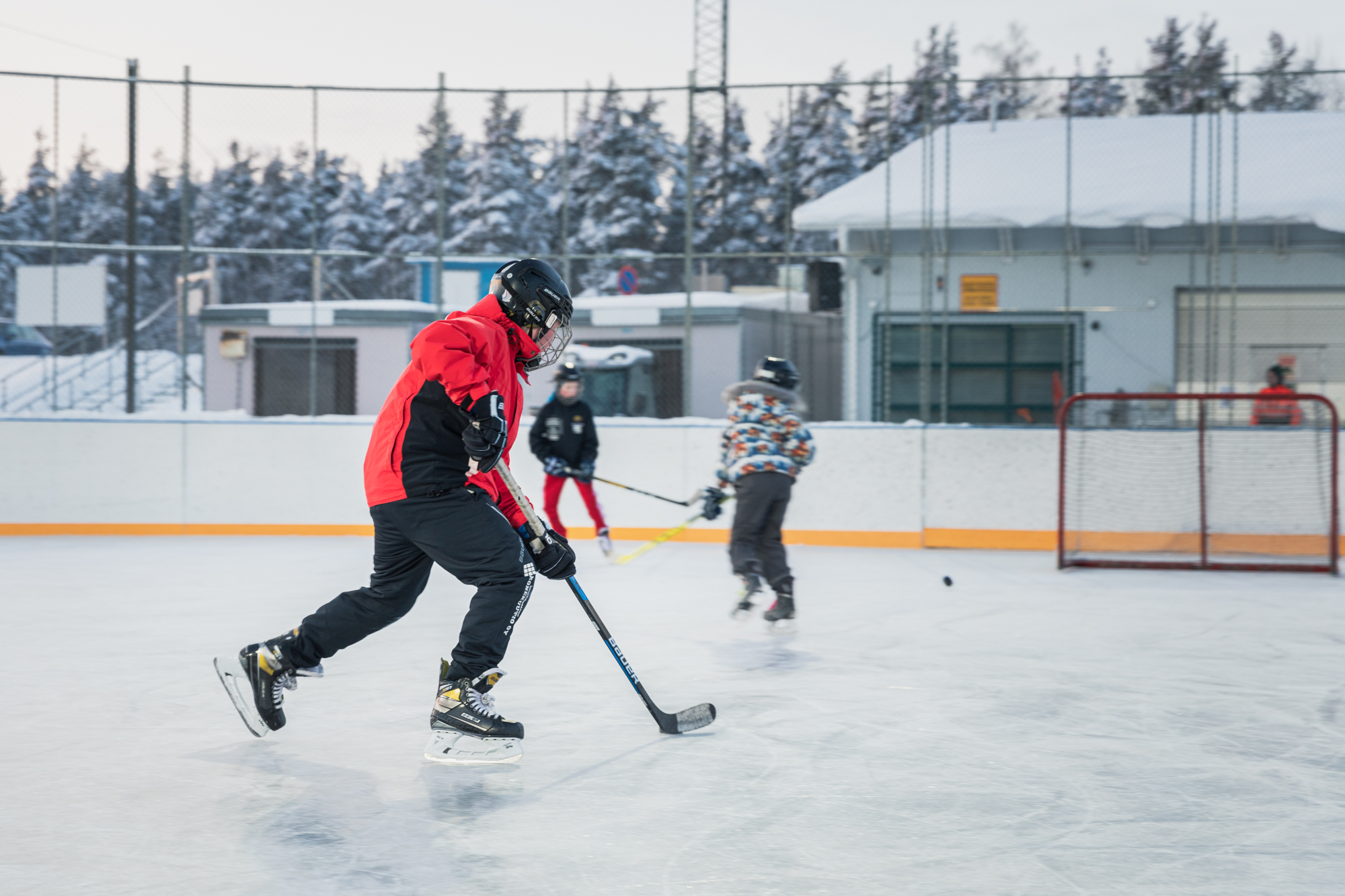 Children playing icehockey.